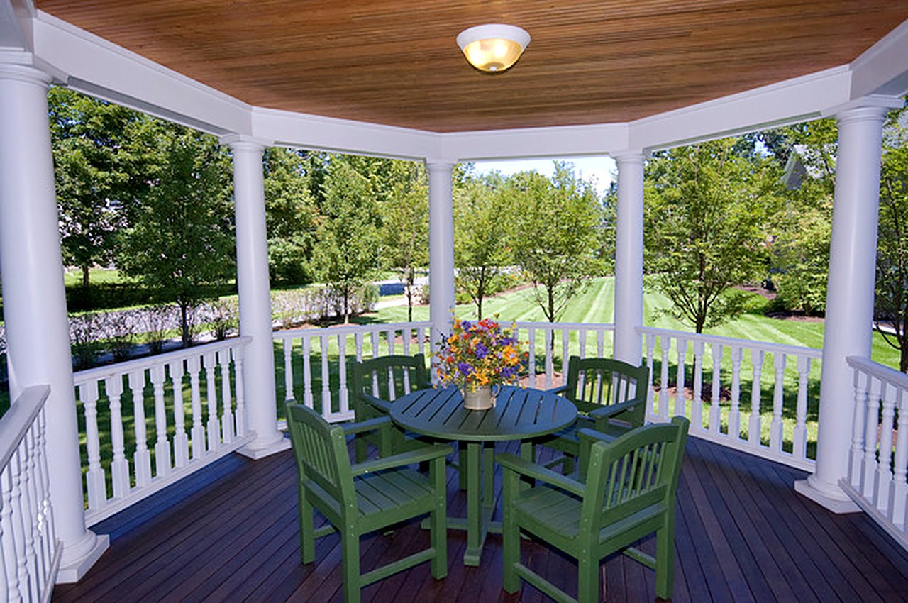 Covered porch pavilion with columns, white railings and a beadboard ceiling