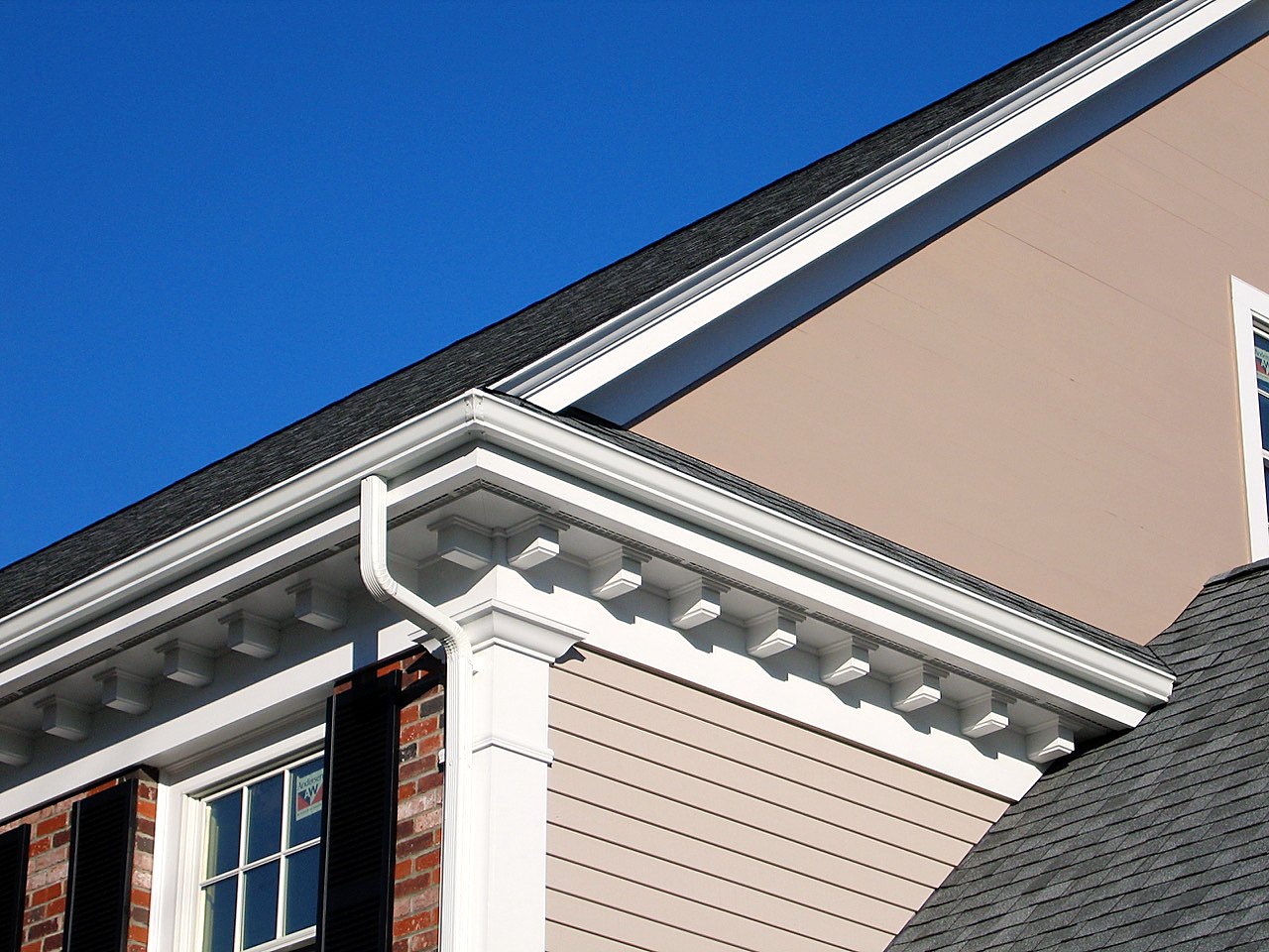 Exterior cornice detail with dentil blocks and a paneled corner return