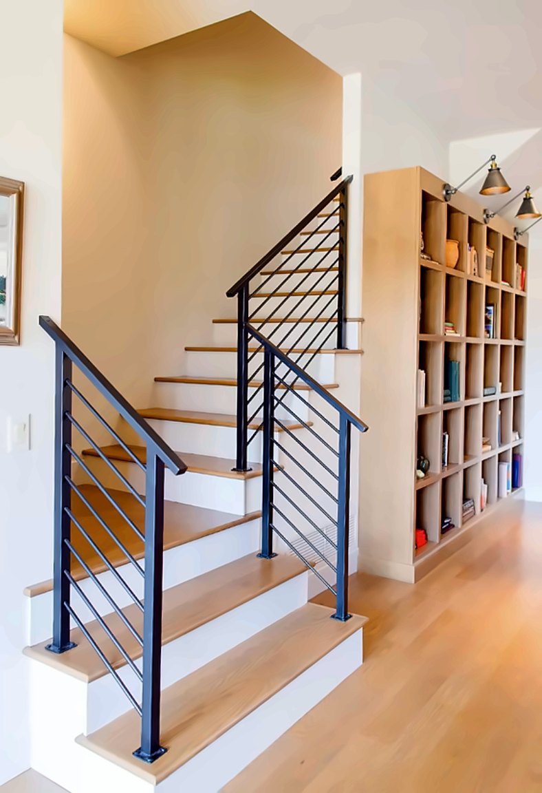 Horizontal-rail stair beside a white-oak cubby bookcase