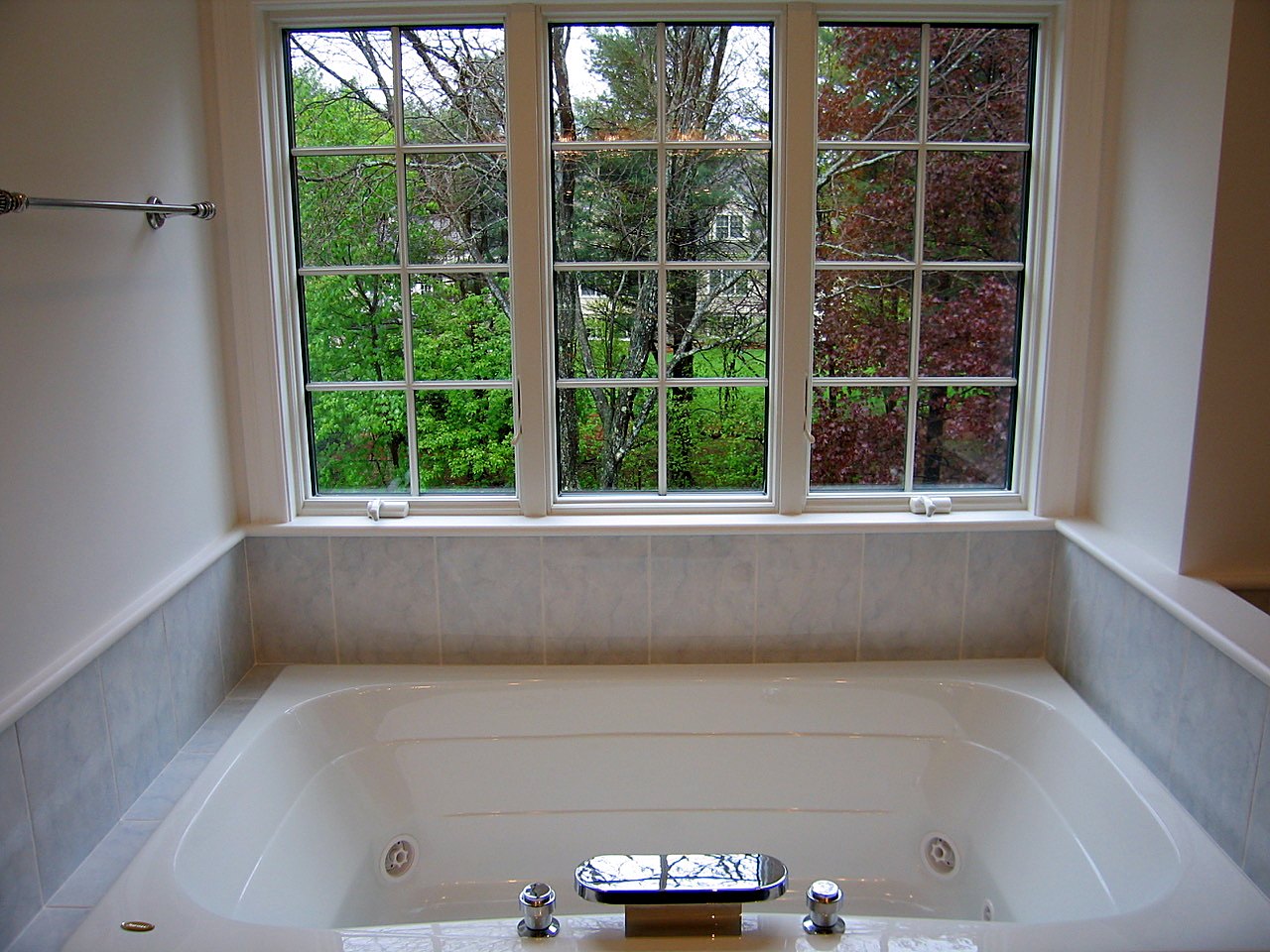 Soaking tub set beneath a triple casement window